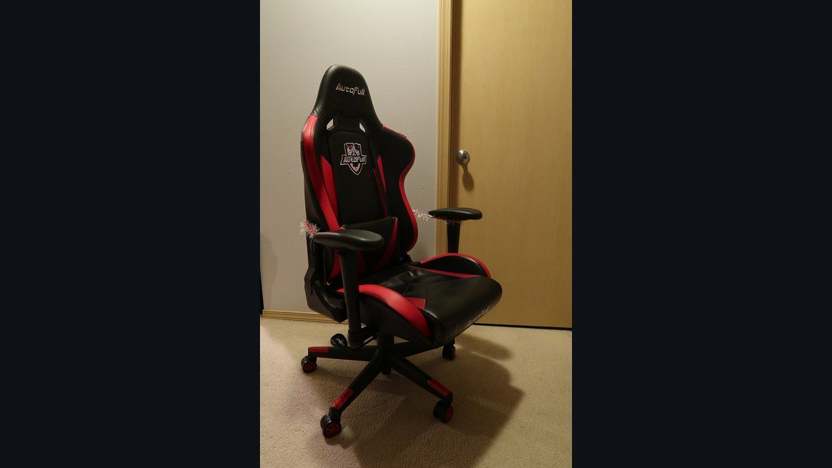 A racing-style gaming chair with adjustable armrests